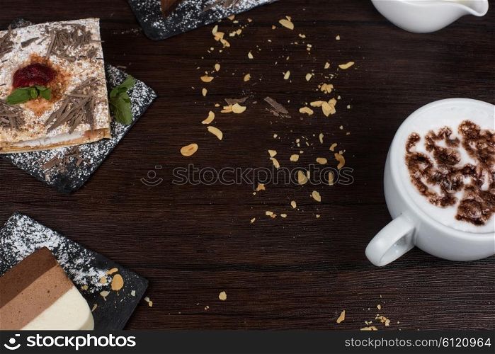 Coffee theme photo. Table with cakes ans coffee cup