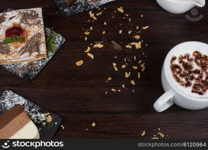 Coffee theme photo. Table with cakes ans coffee cup