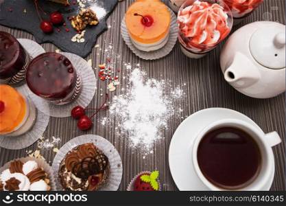 Coffee theme photo. Table with cakes ans tea items