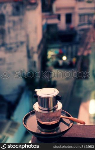 Coffee time at early morning in sunrise at balcony of house, boot for a new day with caffeine drinks, photo of coffee cup from high view among city in warm color
