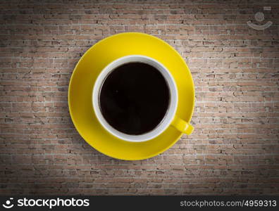 Coffee time. Close up of coffee cup on brick surface