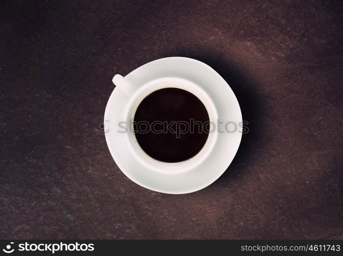 Coffee time. Close up of coffee cup on stone surface