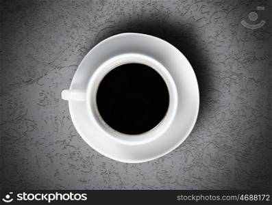 Coffee time. Close up of coffee cup on stone surface
