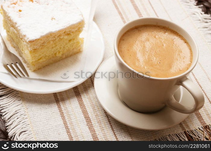 Coffee time concept. Closeup cup with cappuccino mocha and cake on table