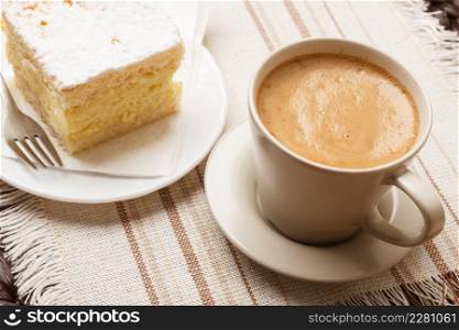 Coffee time concept. Closeup cup with cappuccino mocha and cake on table