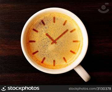coffee time. cup of fresh espresso with clock sign, view from above