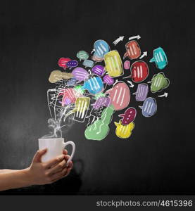 Coffee time. Hand holding coffee cup with speech bubble