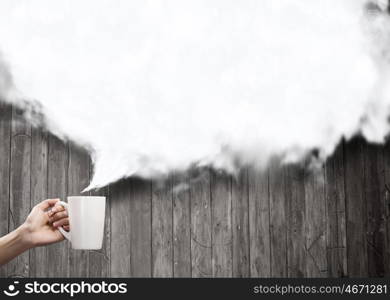 Coffee time. Hand holding coffee cup with speech bubble