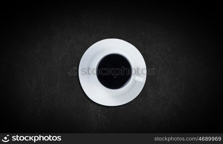 Coffee time. Top view of cup of coffee on dark background