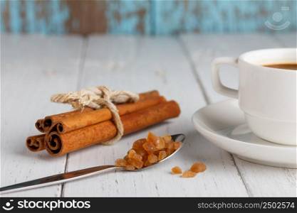 Coffee with caramel sugar and cinnamon on wooden table