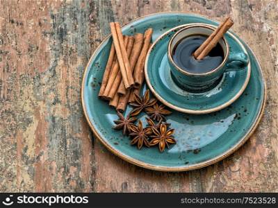Coffee with cinnamon and star anise spices. Vintage style still life