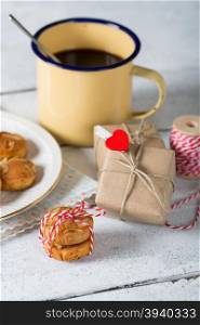 Coffee with delicious homemade cookies and a gift box