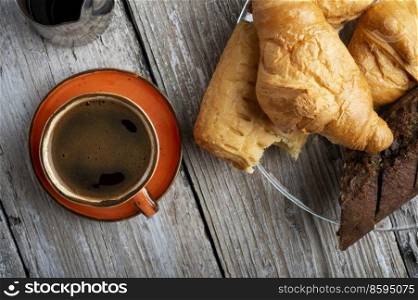 coffee with french baget and croissants on provence style old wooden table. flat lay