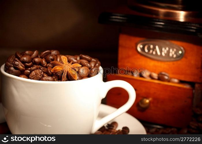 coffee with grinder on background