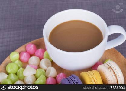 coffee with macaron and Aalaw on wood table background