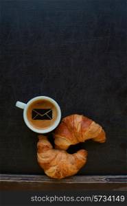 coffee with mail sign and croissant at board