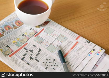 Coffee with newspaper crossword