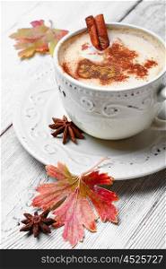 Coffee with spices. Coffee cup with cinnamon and star anise on autumn background