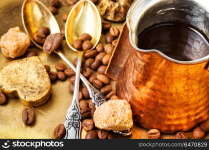 Coffee with sweets. Coffee cezve and beans of Turkish coffee and luxury sweets