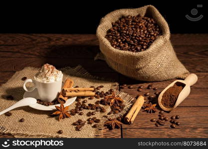 Coffee with whipped cream, cocoa powder, cinnamon and star anise