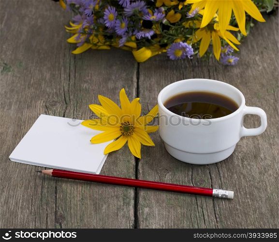 coffee, yellow flower, pencil with paper and wild flowers, a still life, a subject flowers and drinks