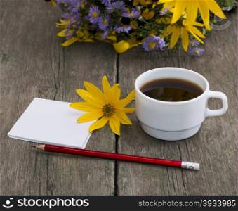 coffee, yellow flower, pencil with paper and wild flowers, a still life, a subject flowers and drinks