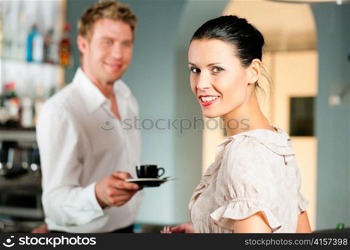 Coffeeshop - barista in cafe waits a coffee to a client
