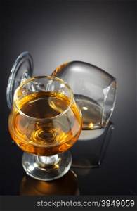 cognac and glass on black background