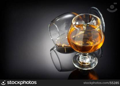 cognac and glass on black background