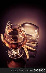 cognac glass on black glossy background