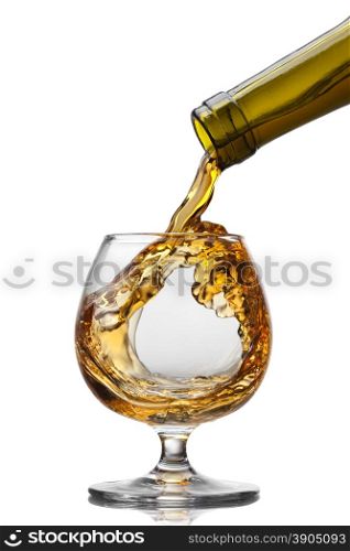 Cognac pouring into glass with splash isolated on white background