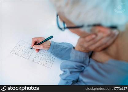 Cognitive training. Senior woman solving sudoku puzzles.. Cognitive Training. Senior Woman Solving Sudoku.