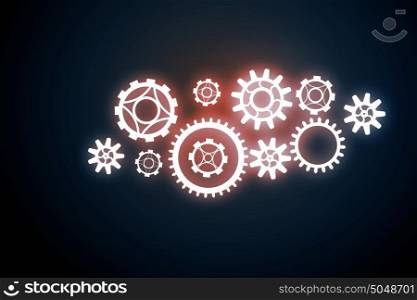 Cogwheels as teamwork concept. Concept of teamwork with gears mechanism on dark background