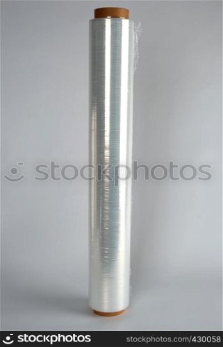 coiled roll of transparent polyethylene for food packaging on a white background