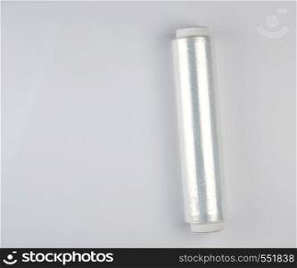 coiled roll of transparent polyethylene for food packaging on a white background, copy space
