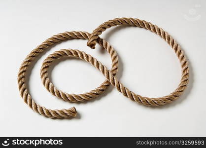 Coiled rope on a white background.