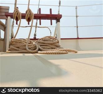 Coiled rope rigging on a sailboat deck.