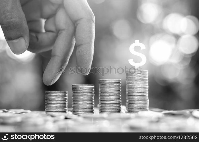 Coin placed four rows. As men&rsquo;s hands are moving their finger to convey financial and business growth.