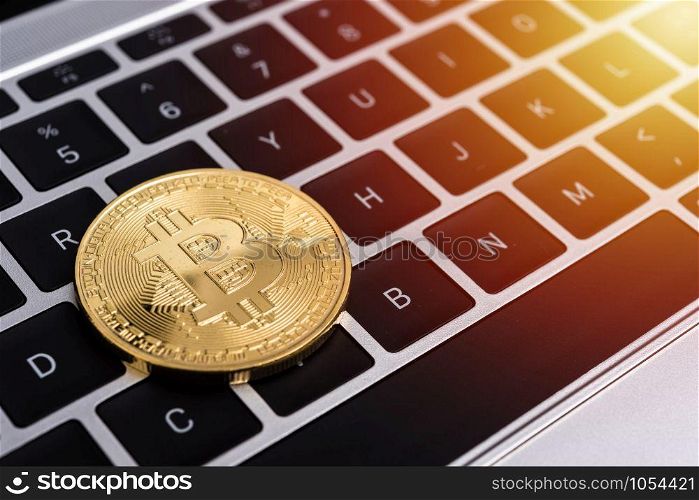 Coin, virtual golden bitcoin money on keyboard laptop computer,