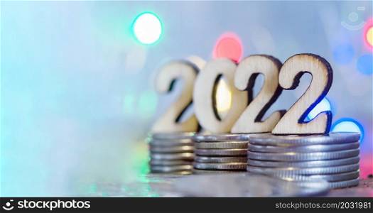 Coins and Figures 2022. Banner 2022. Money stacked in columns.. Banner 2022. Coins and Figures 2022. Money stacked in columns.