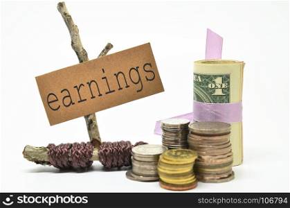 Coins and money with earnings label. Financial concept.