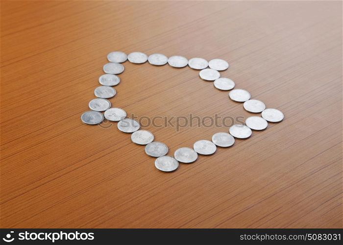 Coins Forming Shape of House