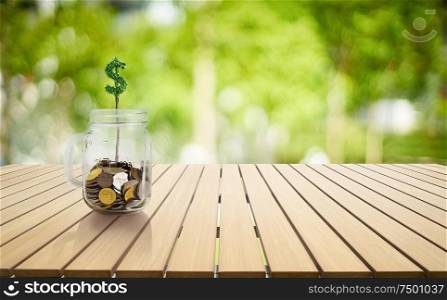 Coins in the glass with Money shape plant growing ,savings,growing,investment,retirement and education concept .