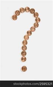 Coins in the shape of a question mark