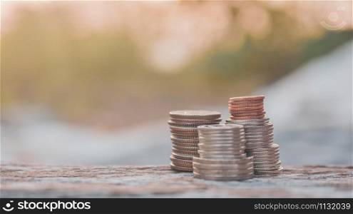 coins stack on wood table sunlight background