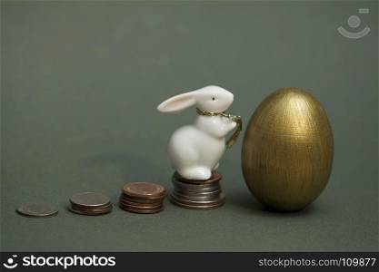 coins stacked up, gold egg and White Rabbit