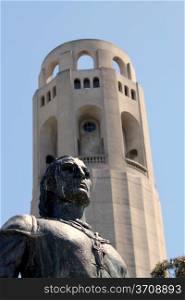 Coit Tower in San Francisco with the statue of Columbus in the front.