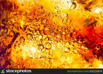 cola drink with ice cubes texture and bubble as a abstract background