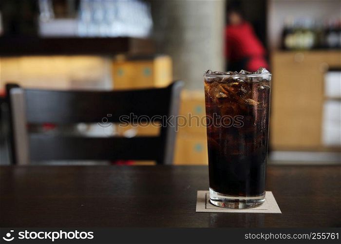 Cola drinking on wood background