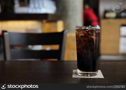 Cola drinking on wood background